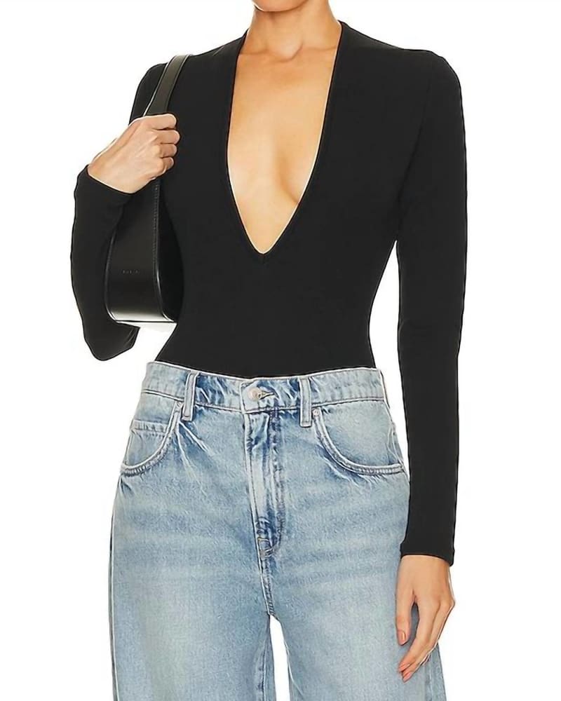 Front of a model wearing a size L Zena Deep V Bodysuit in Black in Black by AGOLDE. | dia_product_style_image_id:364324